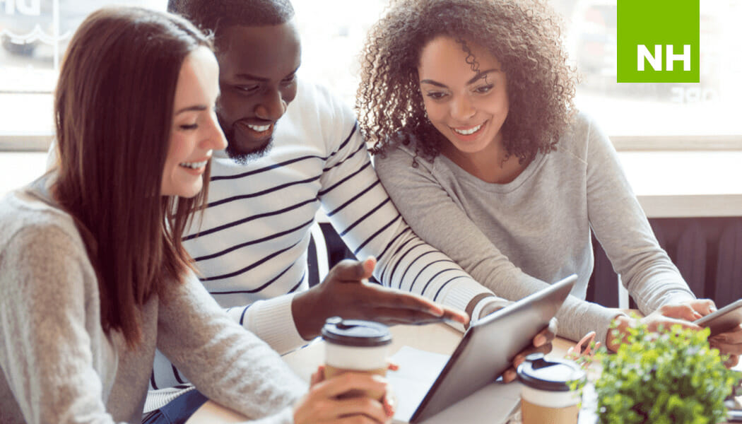 Young people smiling at computer