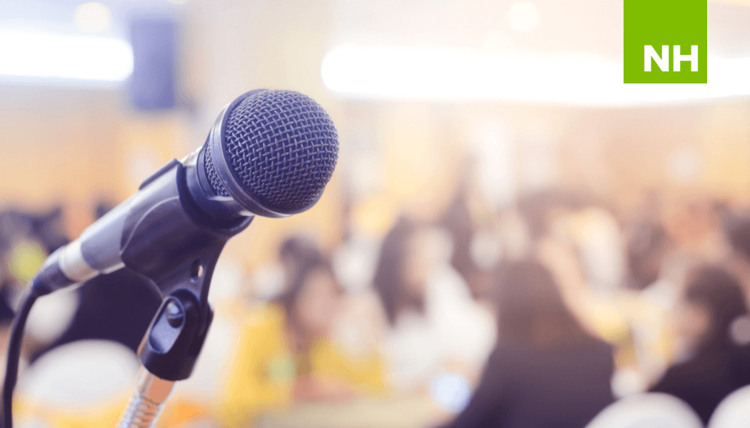 Microphone with nonprofit conference attendees in the background